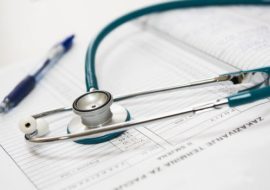 stethoscope on paper with a pen