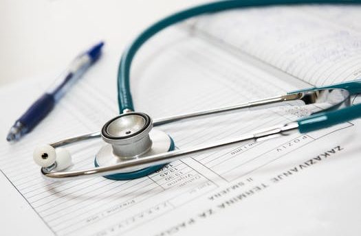 stethoscope on paper with a pen